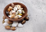 Assorted Cowrie Shells (approx. 10-15 shells .75-1.5 inches). Multiple earthly colored shells in a pile. Copyright 2022 SeaShellSupply.com.