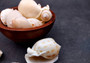 Japanese Bonnet Seashells - India - Phalium Bisulcatum - (10 shells approx. 1.5-2 inches). Multiple white spiral shells with light brown coloring in different shades laying next to each other. Copyright 2022 SeaShellSupply.com.