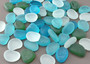 Beach Glass - Rounded Blue, Green & White Assorted Pebbles - (approx. 1 Kilogram/2.2 lbs. 1-1.5 inches). Multiple colored pebbles in a pile. Copyright 2022 SeaShellSupply.com.