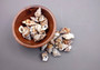 Granulate Frog Seashells (10 pcs.) - Bursa Granularis. Multiple earthly toned, ribbed, and spiral shells in a pile. Copyright 2024 SeaShellSupply.com.