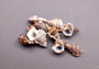 Granulate Frog Seashells (10 pcs.) - Bursa Granularis. Multiple earthly toned, ribbed, and spiral shells in a pile. Copyright 2024 SeaShellSupply.com.