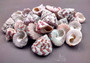 Christmas Tree Top Shells - Trochus Radiatus - (10 shells approx. .5-1 inches). Different shades of Orange and Teal shells in pile. Copyright 2024 SeaShellSupply.com.