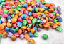 Dyed Umbonium Seashells - Button Top Shells - (approx. 1/2 Cup 210-230 shells 1/8-3/8 inches). Rainbow colored shells in pile. Copyright 2024 SeaShellSupply.com.