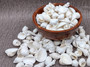 White Seashell Medium Wedding Mix - (1 Kilogram/2.2 lbs. 100-120 shells approx. 1-2 inches).Multiple differently shaped and textured shells all bright white in a pile. Copyright 2022 SeaShellSupply.com.
