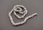 Tiger Puka Shell Strand (16 inches x 4-6mm). Multiple strands of white beaded strings. Copyright 2024 SeaShellSupply.com.