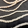 White Puka Shell Necklace - (1 necklace 18 inches x 4-5mm) on grey background. Copyright 2026 SeaShellSupply.com.
