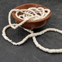 White Puka Shell Necklace - (1 necklace 18 inches x 4-5mm) on grey background. Copyright 2026 SeaShellSupply.com.\n