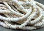 White Puka Shell Necklace - (1 necklace 18 inches x 4-5mm) on grey background. Copyright 2022 SeaShellSupply.com.
