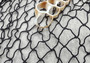 Fishing Net - Used (4 X 9 feet). One black tied fishing net that comes folded and banded. Copyright 2022 SeaShellSupply.com.