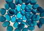 Beach Glass - Rounded Aqua Blue Pebbles - (approx. 1 Kilogram/2.2 lbs. 1-1.5 inches). Multiple smooth blue glass pebbles in a pile. Copyright 2025 SeaShellSupply.com.