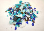 Beach Glass - Medium Tumbled Rough Brown, White & Blue Pacific Assorted - (approx. 1 Kilogram/2.2 lbs. .5-1.25 inches). Multiple blue, white, and brown fragments in a pile. All different shapes and sizes. Copyright 2025 SeaShellSupply.com.