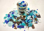 Beach Glass - Medium Tumbled Rough Brown, White & Blue Pacific Assorted - (approx. 1 Kilogram/2.2 lbs. .5-1.25 inches). Multiple blue, white, and brown fragments in a pile. All different shapes and sizes. Copyright 2025 SeaShellSupply.com.