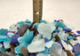 Beach Glass - Medium Tumbled Rough Brown, White & Blue Pacific Assorted - (approx. 1 Kilogram/2.2 lbs. .5-1.25 inches). Multiple blue, white, and brown fragments in a pile. All different shapes and sizes. Copyright 2025 SeaShellSupply.com.