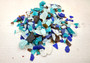 Beach Glass - Medium Tumbled Rough Brown, White & Blue Pacific Assorted - (approx. 1 Kilogram/2.2 lbs. .5-1.25 inches). Multiple blue, white, and brown fragments in a pile. All different shapes and sizes. Copyright 2025 SeaShellSupply.com.