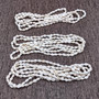 White Nassa Shell Leis (3 Leis Approx. .25 x 28 Inches). White little shells strung through string. Copyright 2026 SeaShellSupply.com.