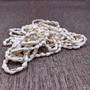 White Nassa Shell Leis (3 Leis Approx. .25 x 28 Inches). White little shells strung through string. Copyright 2026 SeaShellSupply.com.