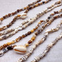 Natural Nassa Shell Leis (3 Leis Approx. .25 x 17 Inches each). Two Different assortment of shells on a necklace brown and tan grouping.Copyright 2026 SeaShellSupply.com.