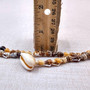 Natural Nassa Shell Leis (3 Leis Approx. .25 x 17 Inches each). Two Different assortment of shells on a necklace brown and tan grouping.Copyright 2026 SeaShellSupply.com.