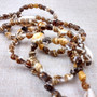 Natural Nassa Shell Leis (3 Leis Approx. .25 x 17 Inches each). Two Different assortment of shells on a necklace brown and tan grouping.Copyright 2026 SeaShellSupply.com.