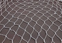 White Decorative Fish Net - (1 Net approx. 3.3 feet x 6.6 feet) on greyish background. Copyright 2022 SeaShellSupply.com.