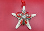 White Knobby Starfish Ornament (1 star approx. 4-5 inches) on red background. Copyright 2022 SeaShellSupply.com.

