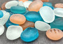 Beach Glass - Rounded Blue, Peach & White Assorted Pebbles - (approx. 1 Kilogram/2.2 lbs. 1-1.5 inches). Multiple colored pebbles in a pile. Copyright 2022 SeaShellSupply.com.