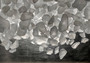 Beach Glass - Small Tumbled Rough Frosty White - (approx. 1 Kilogram/2.2 lbs. .25-1 inches). Multiple stone pebbles in a pile. Copyright 2025 SeaShellSupply.com.