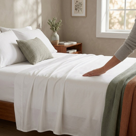 white-cotton-sateen-flat-sheet-draped-over-bed-showing-smooth-soft-finish