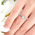 dainty moonstone ring on a finger