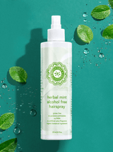 Hairspray on a greenish/blue background with leaves