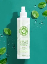 Hairspray on a greenish/blue background with leaves