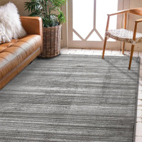 Arlo Textured Grey Rug in a living space with a seating arrangement .