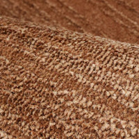 Arlo Textured Terracotta Rug in a living space with a seating arrangement.