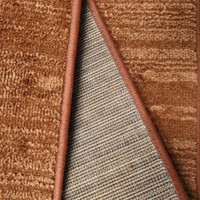 Arlo Textured Terracotta Rug folded, exposing the backing.