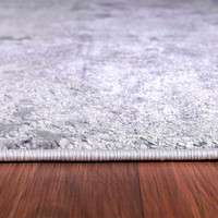silver grey abstract rug  closeup edge on wooden floor