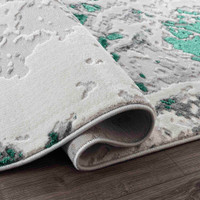 aqua grey abstract rug runner folded on wooden floor