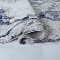 navy grey abstract rug runner folded on a white floor