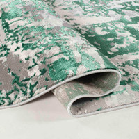 aqua grey abstract rug runner folded on a white floor