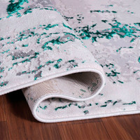 aqua grey abstract rug runner folded on a wooden floor
