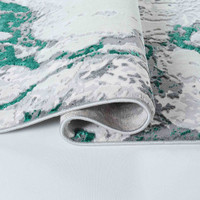 aqua grey abstract rug runner folded on a white floor