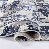 navy grey abstract rug runner folded on a white floor