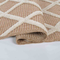 cream aztec rug folded on white floor