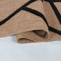 black natural geometric rug folded on white floor