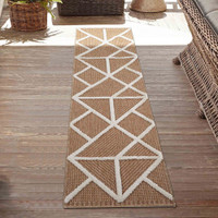 cream natural geometric rug runner outdoors on decking