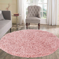 plain shaggy baby pink rug circle in a living room