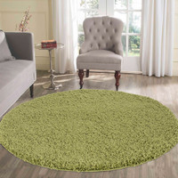 plain shaggy green rug circle in living room