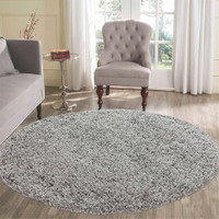 plain shaggy grey circle rug in a living room
