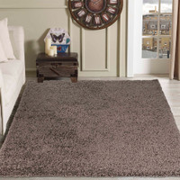 plain shaggy taupe rug in a living room