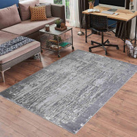 modern abstract abrasion grey rug in a living room