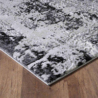 modern abstract acrylic black rug closeup corner on a wooden floor